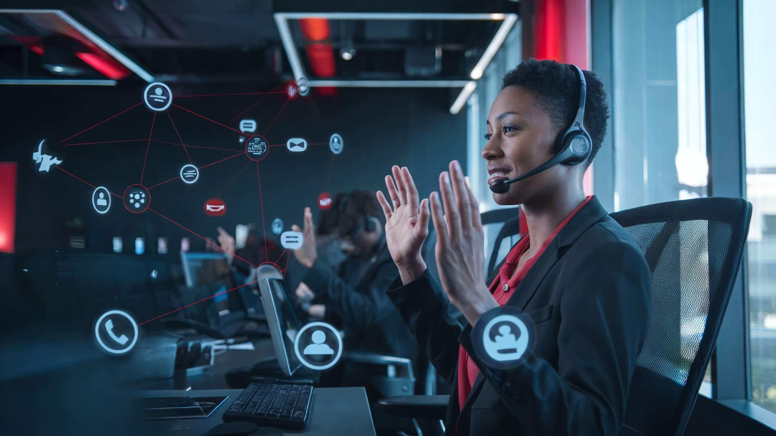 Woman wearing a headset gesturing during a conversation in a modern office, surrounded by symbolic network icons such as phone, message, and user profiles, representing digital communication and collaboration.